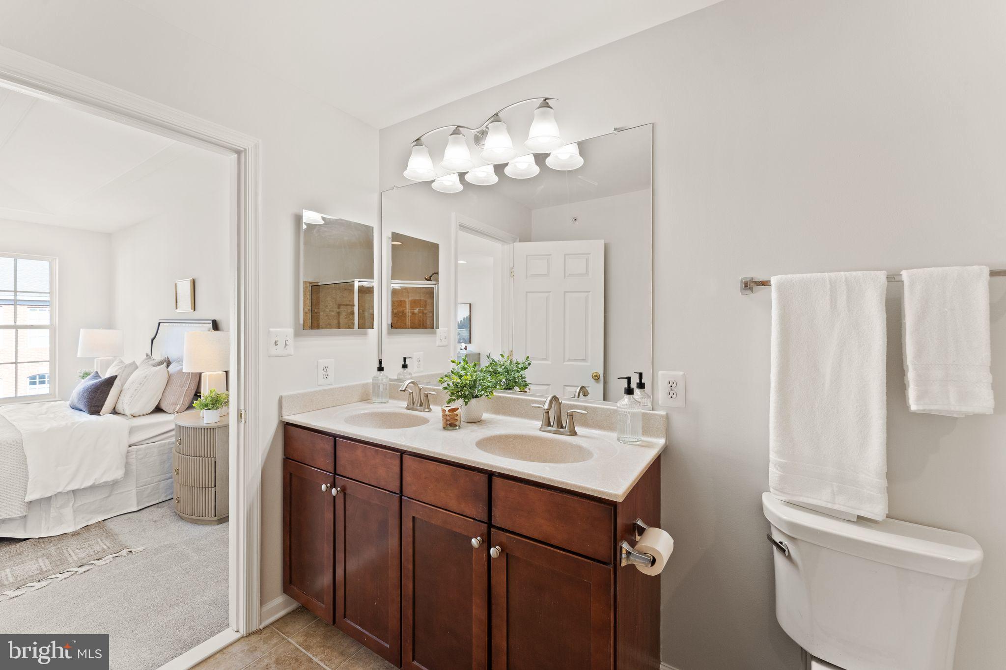 6072 Wicker Lane, Unit 160 Centreville, VA 20121 - Photo 37 of 58 a bathroom with a double vanity sink mirror and toilet