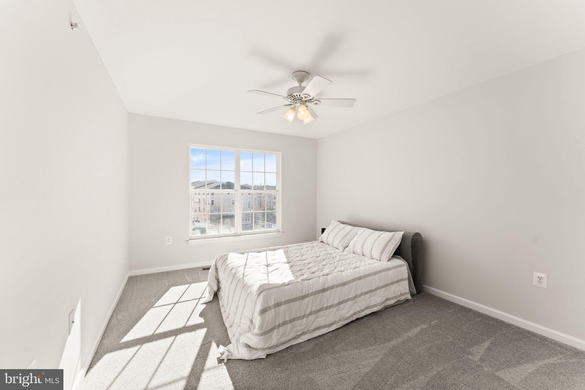 6072 Wicker Lane, Unit 160 Centreville, VA 20121 - Photo 39 of 58 a bedroom with a bed and a window