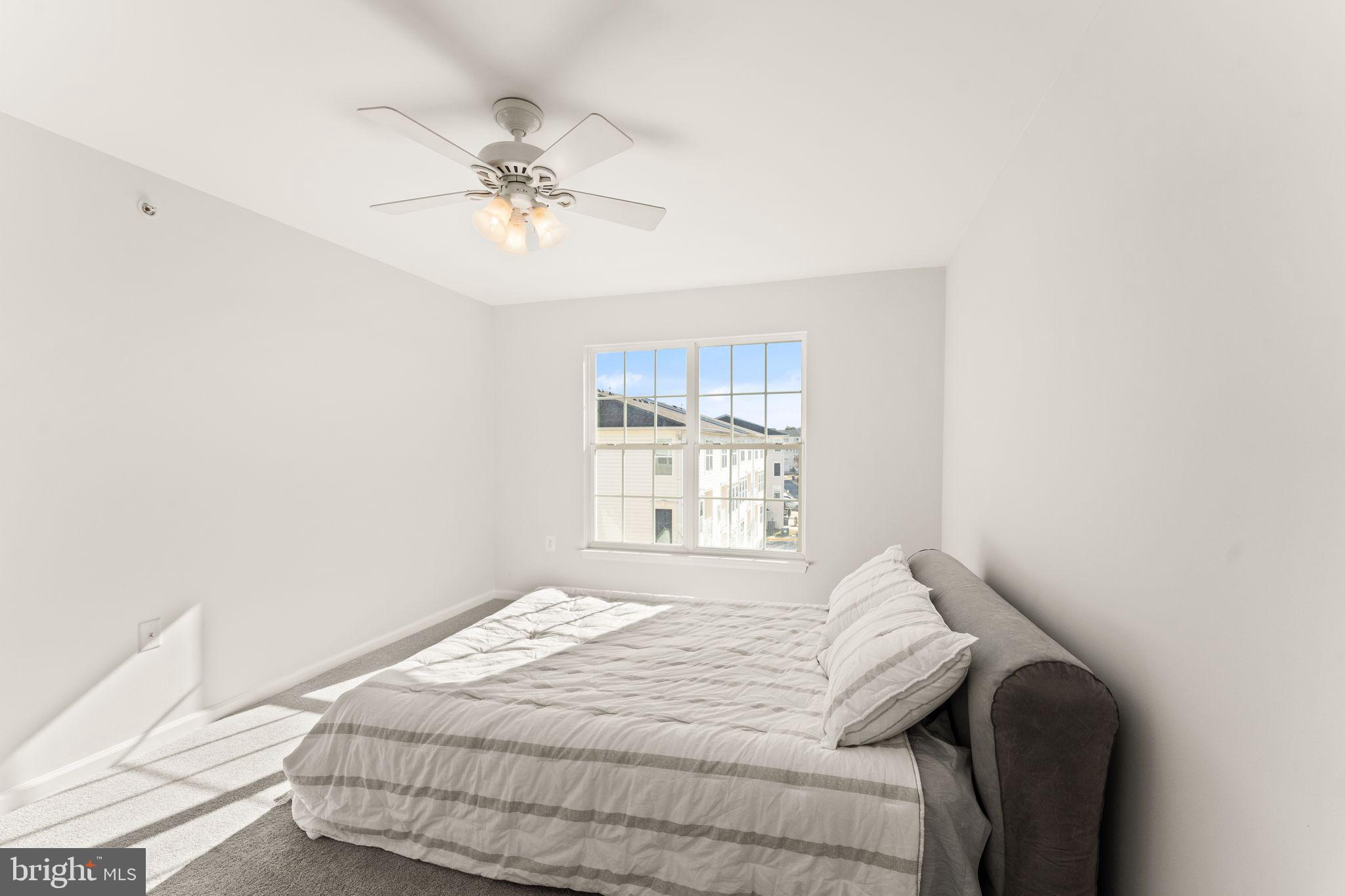 6072 Wicker Lane, Unit 160 Centreville, VA 20121 - Photo 40 of 58 a bedroom with a bed and a window