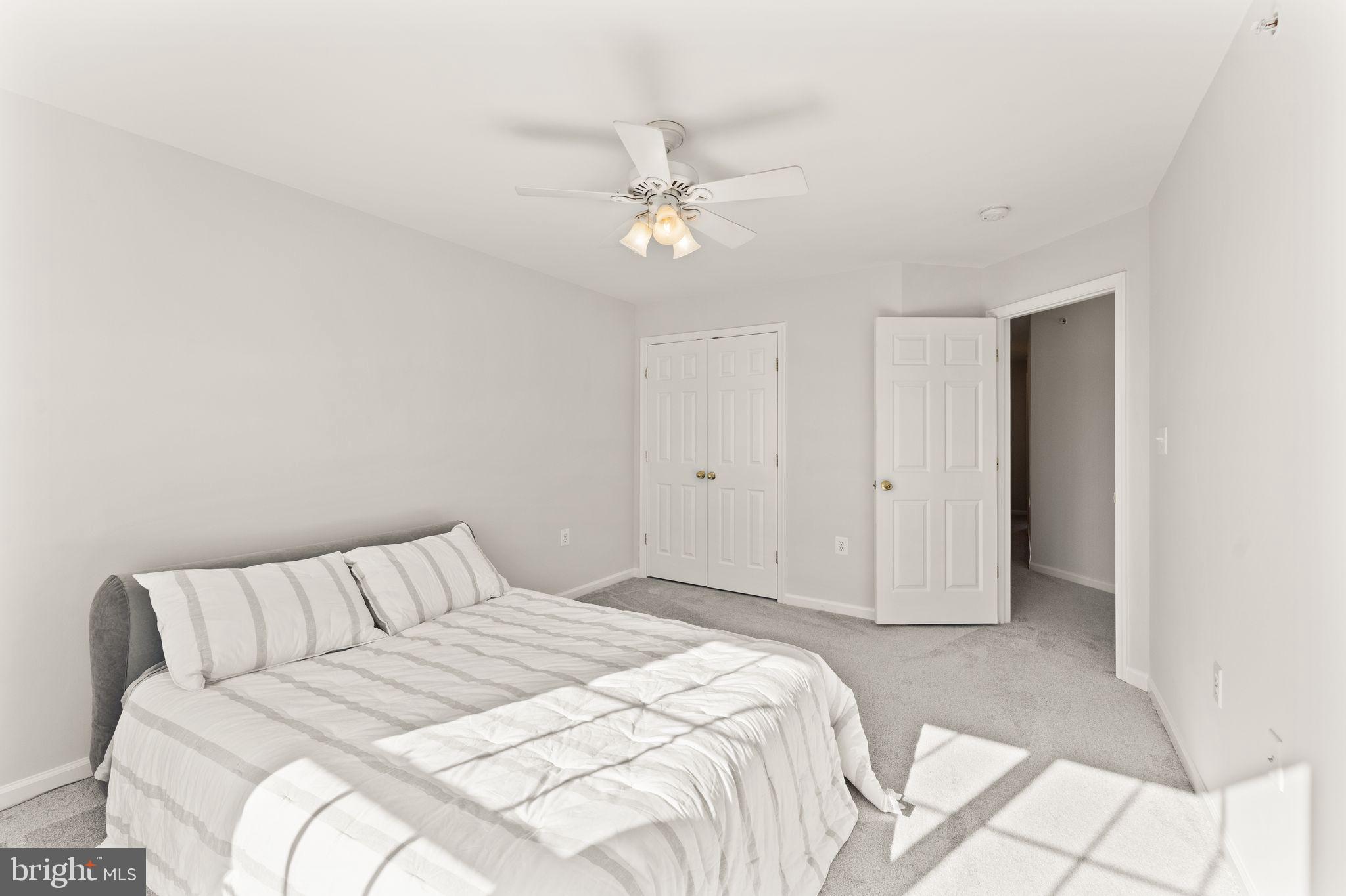 6072 Wicker Lane, Unit 160 Centreville, VA 20121 - Photo 41 of 58 a bedroom with a bed and a chandelier
