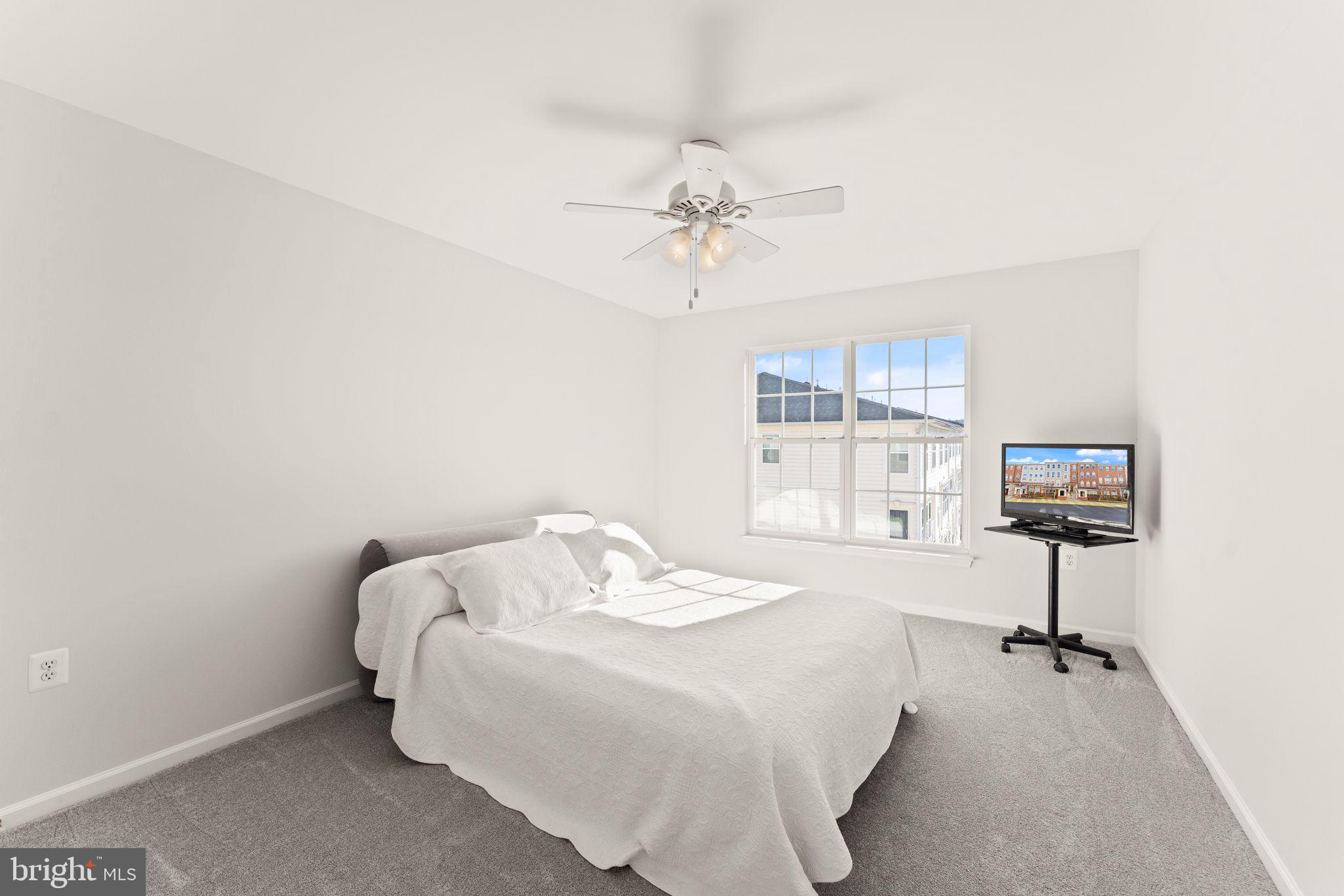 6072 Wicker Lane, Unit 160 Centreville, VA 20121 - Photo 42 of 58 a bedroom with a bed and a chair