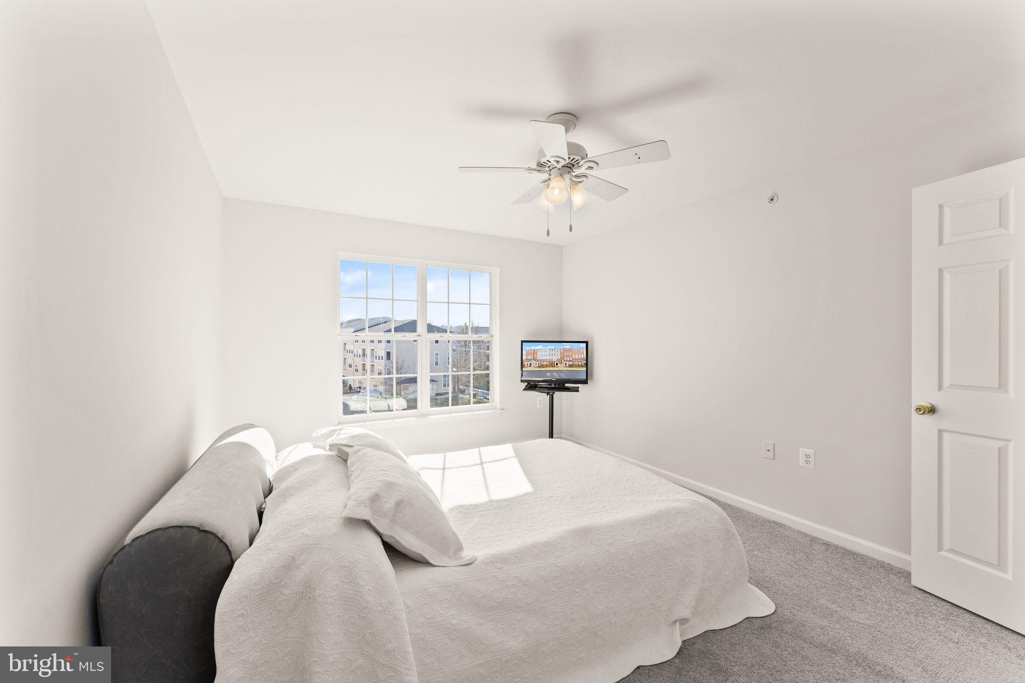 6072 Wicker Lane, Unit 160 Centreville, VA 20121 - Photo 43 of 58 a bedroom with a bed and a window