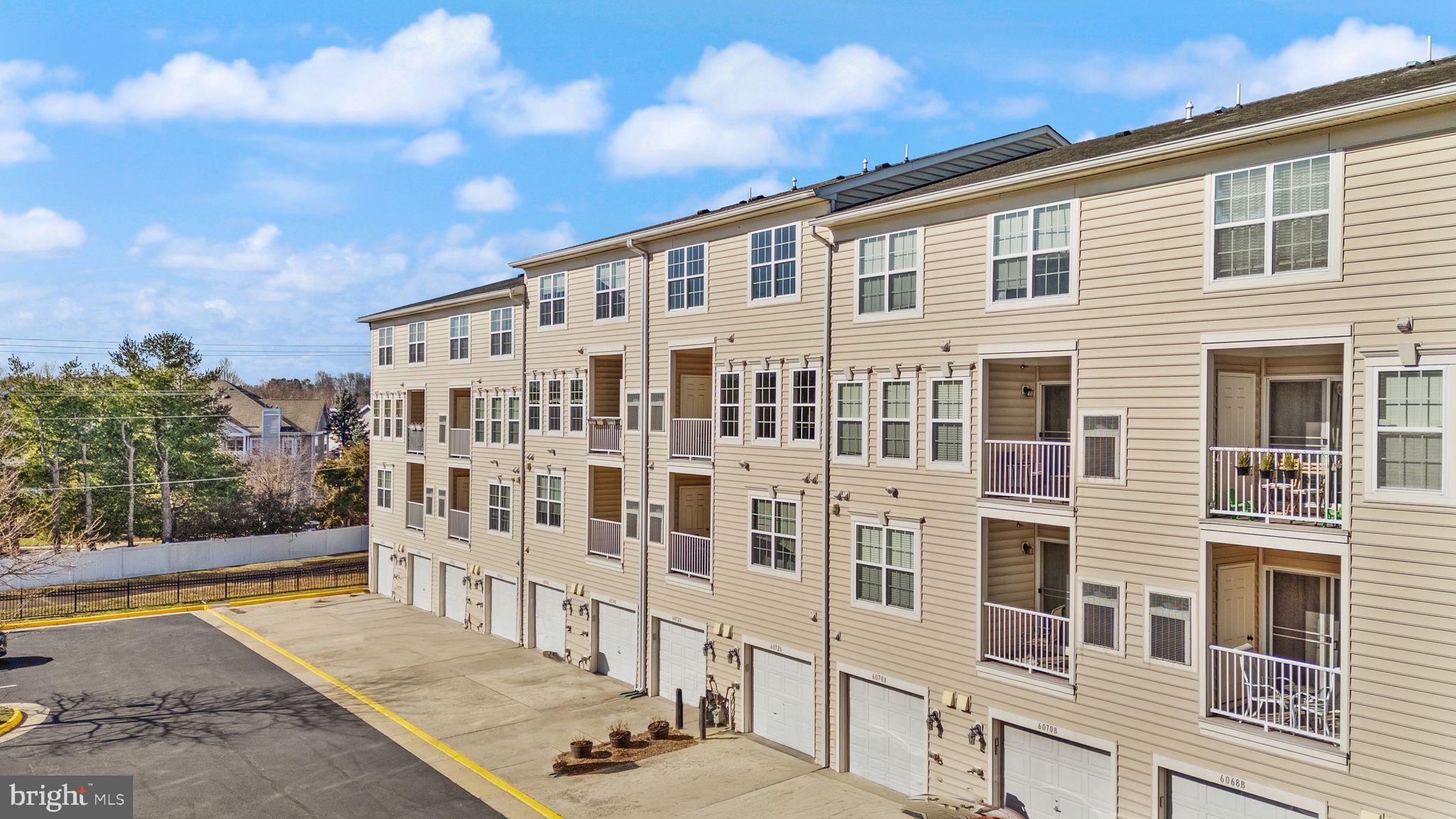 6072 Wicker Lane, Unit 160 Centreville, VA 20121 - Photo 50 of 58 a front view of a building with glass windows and palm trees