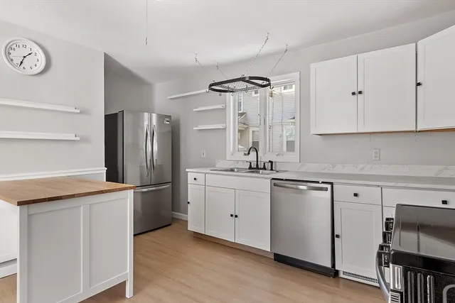 a kitchen with stainless steel appliances a refrigerator and a sink