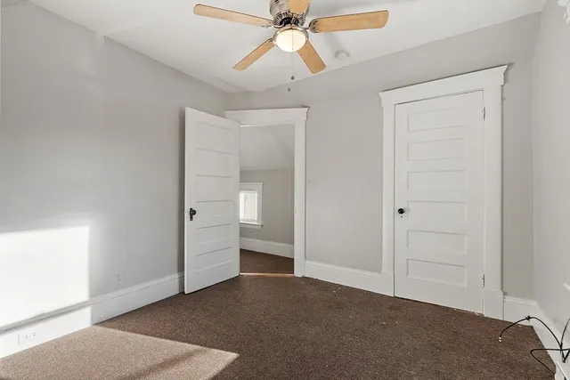 an empty room with windows and closet
