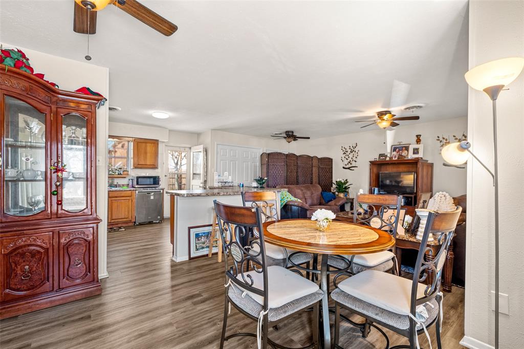 1809 Beverly Street Irving, TX 75061 - Photo 12 of 24 a view of a dining room with furniture a chandelier and wooden floor