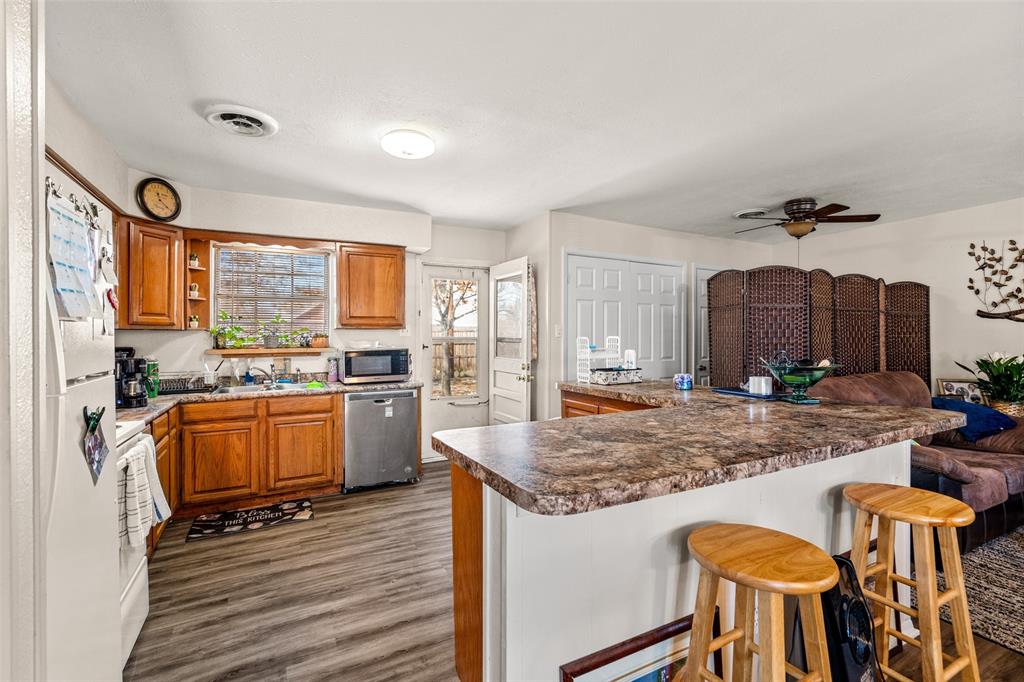 1809 Beverly Street Irving, TX 75061 - Photo 13 of 24 a kitchen with granite countertop kitchen island wooden cabinets and stainless steel appliances