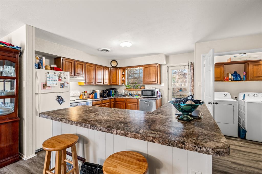 1809 Beverly Street Irving, TX 75061 - Photo 14 of 24 a large kitchen with stainless steel appliances granite countertop a lot of counter space and a living room