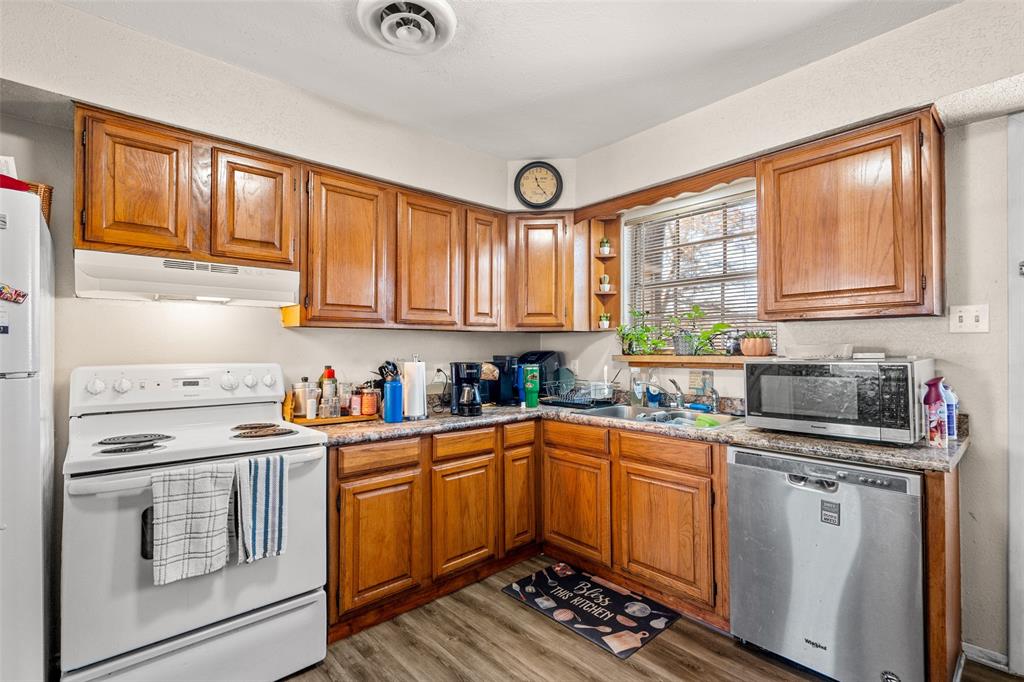 1809 Beverly Street Irving, TX 75061 - Photo 15 of 24 a kitchen with a sink stove top oven and cabinets