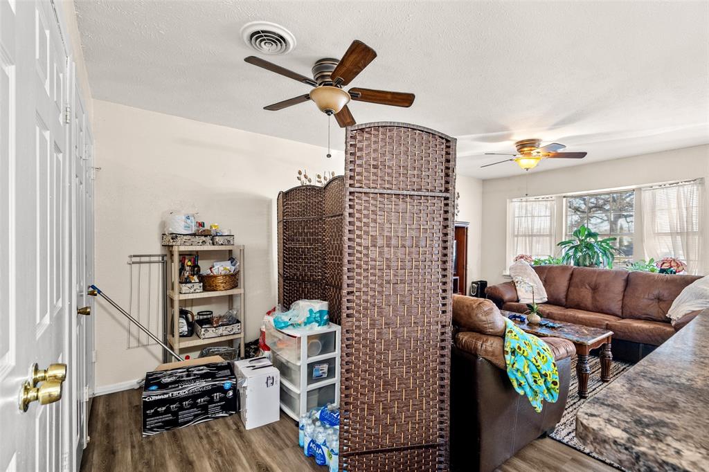 1809 Beverly Street Irving, TX 75061 - Photo 18 of 24 a living room with furniture and a book shelf