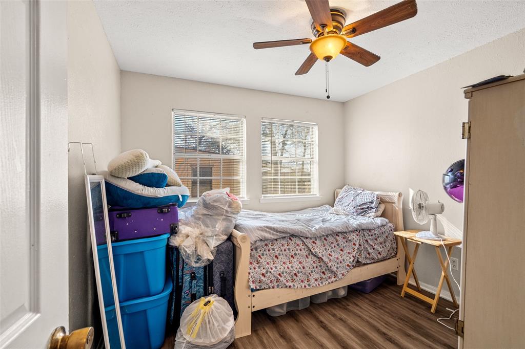 1809 Beverly Street Irving, TX 75061 - Photo 23 of 24 a bedroom with a bed and a chandelier
