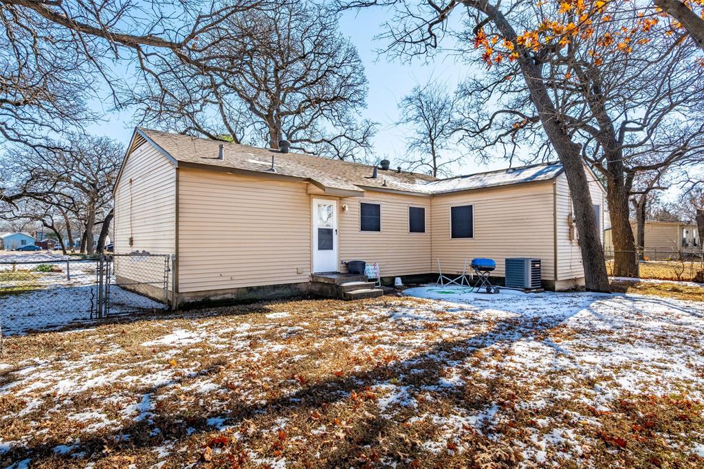 1809 Beverly Street Irving, TX 75061 - Photo 6 of 24 a view of a house with a yard covered in snow