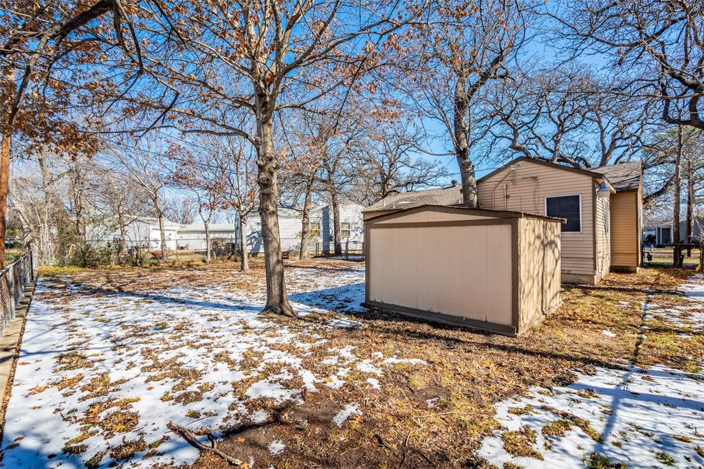 1809 Beverly Street Irving, TX 75061 - Photo 8 of 24 a white house that has a tree in front of it