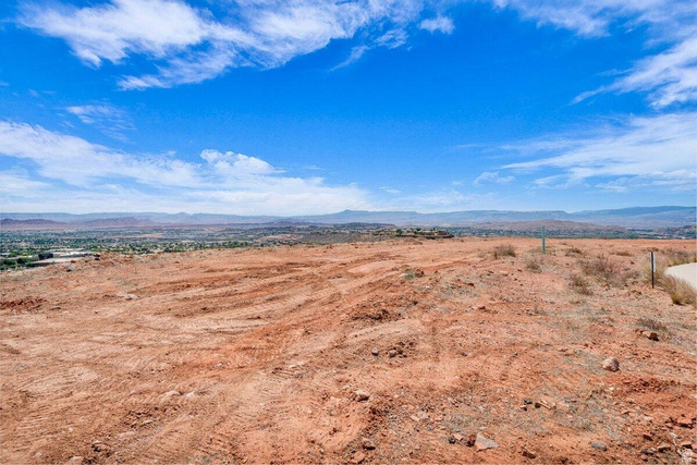 Undisclosed Address St. George, UT 84770 - Photo 7 of 11 Expansive undeveloped land featuring a broad, flat terrain of reddish-brown earth, ideal for new construction