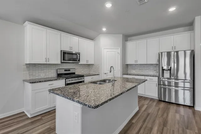 a kitchen with a refrigerator sink and microwave