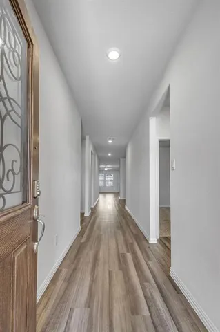 a view of gallery with wooden floor