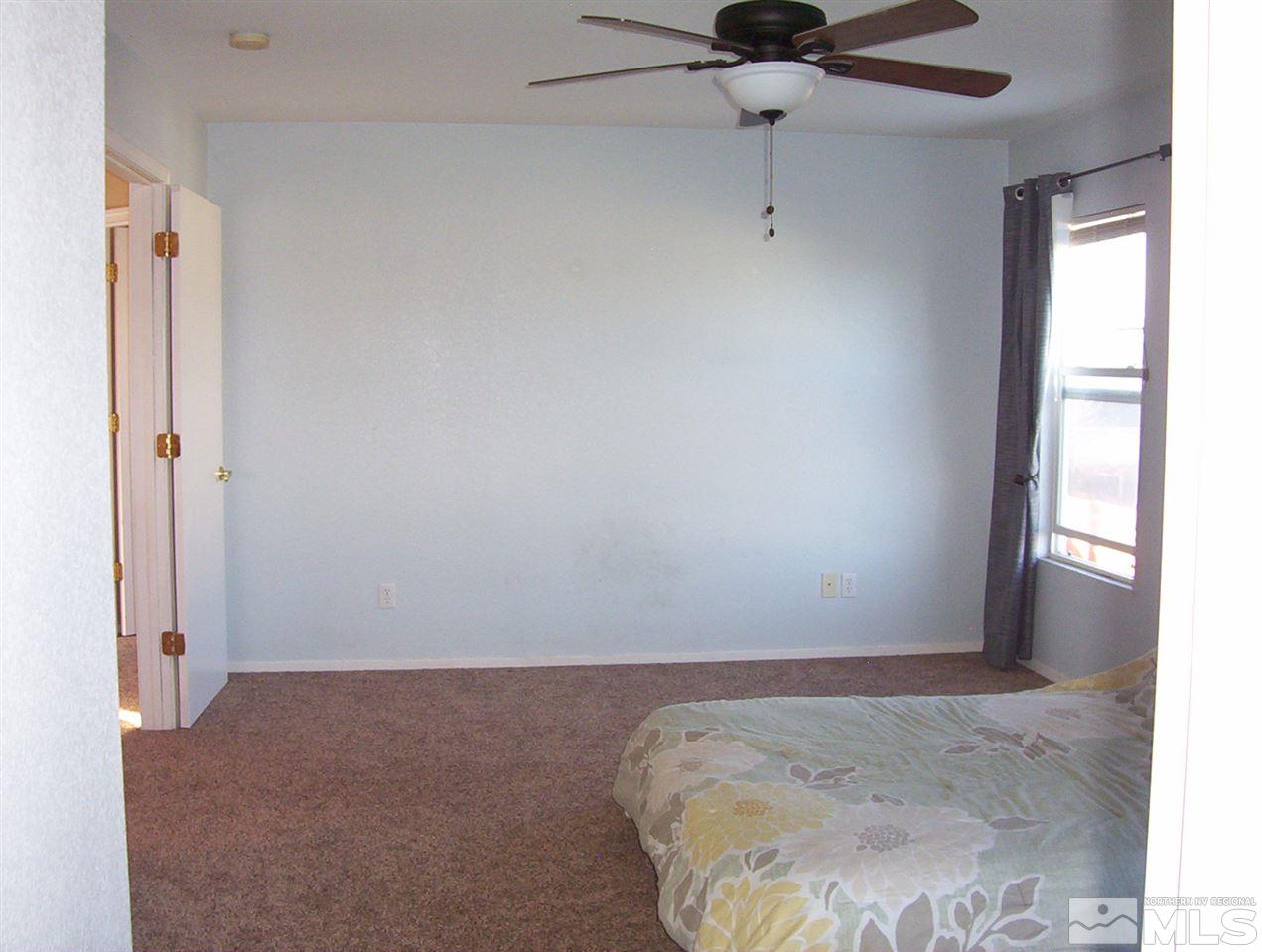 7695 Corso Street Reno, NV 89506 - Photo 17 of 25 a view of a livingroom with a ceiling fan and window