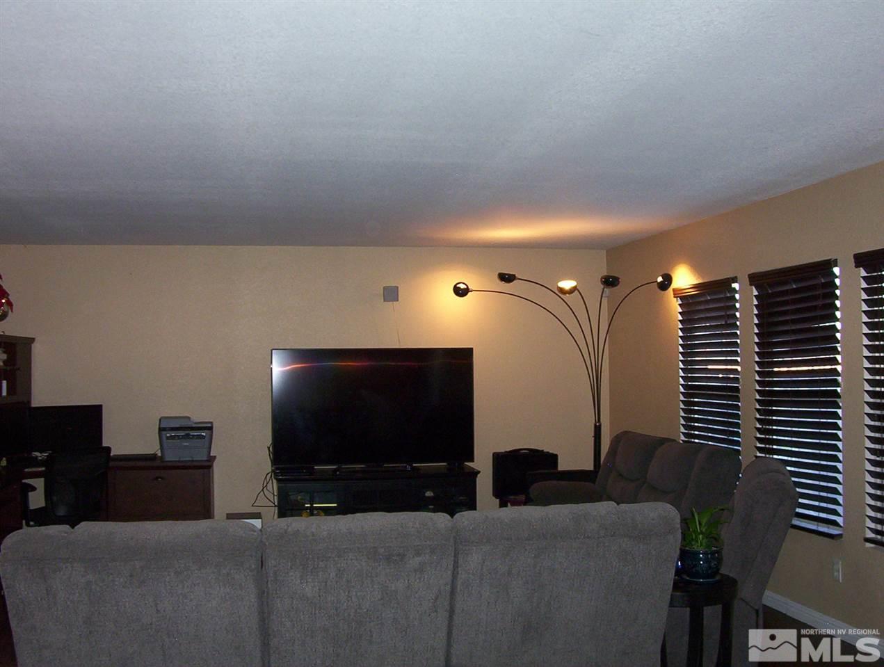 7695 Corso Street Reno, NV 89506 - Photo 8 of 25 a living room with furniture and a flat screen tv