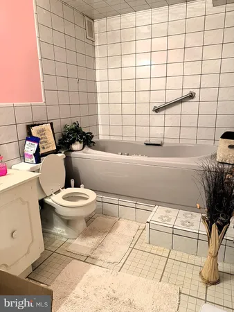 a bathroom with a toilet a sink and shower
