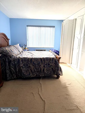 a bedroom with a bed a window and a couch
