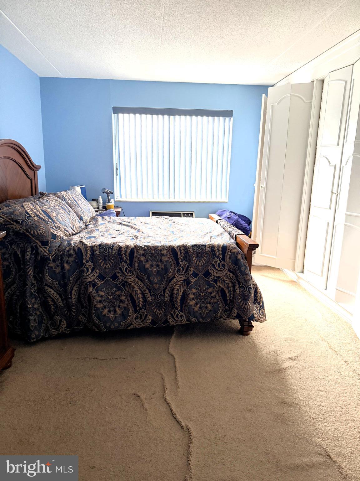 860 Lower Ferry Road, Unit 4C Ewing, NJ 08628 - Photo 13 of 27 a bedroom with a bed a window and a couch