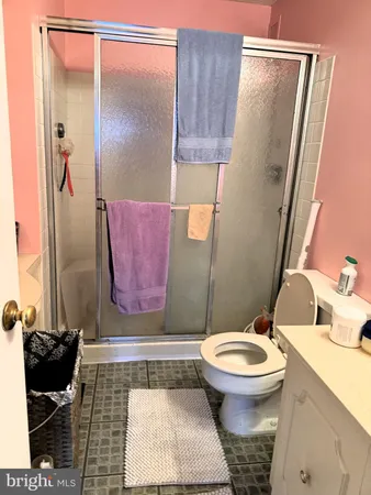 a bathroom with a toilet and a shower