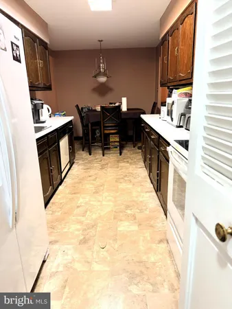 a kitchen with stainless steel appliances kitchen island granite countertop a sink a stove and a refrigerator