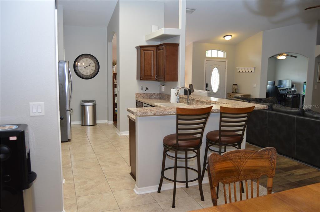 2291 Danforth Road Spring Hill, FL 34608 - Photo 18 of 57 a dining room with furniture and a clock