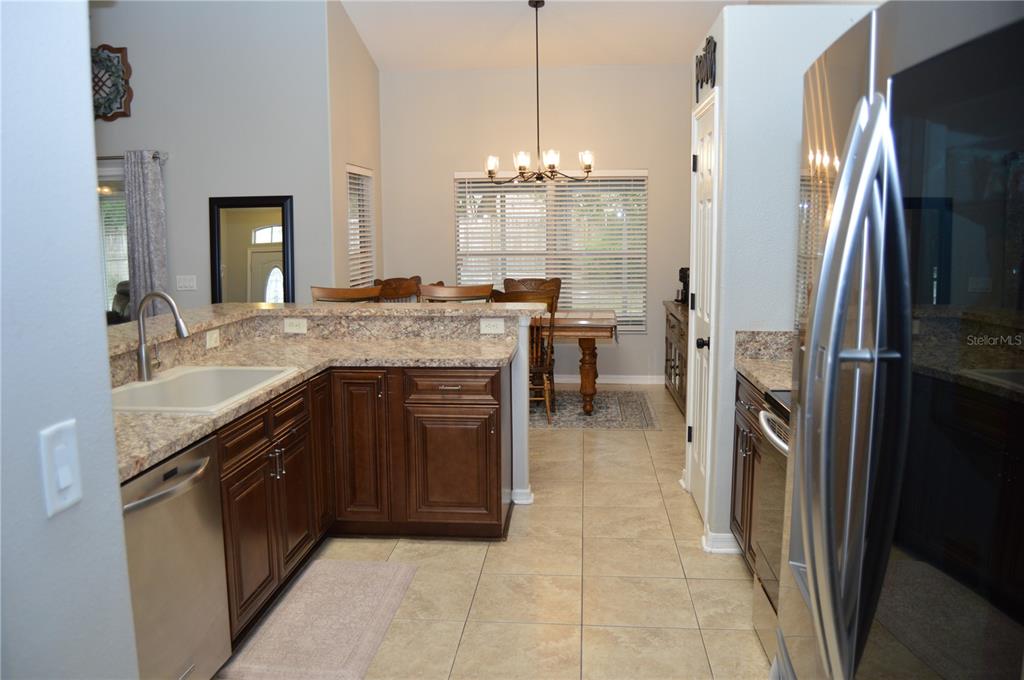 2291 Danforth Road Spring Hill, FL 34608 - Photo 21 of 57 a kitchen with a sink refrigerator and cabinets