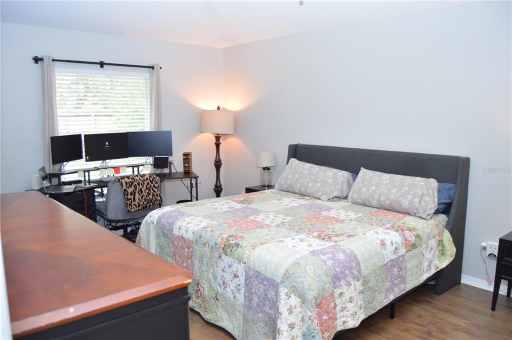 2291 Danforth Road Spring Hill, FL 34608 - Photo 24 of 57 a large bed sitting in a bedroom next to a window