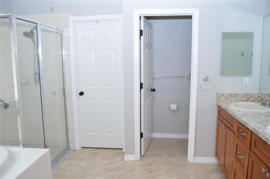 2291 Danforth Road Spring Hill, FL 34608 - Photo 26 of 57 a bathroom with a granite countertop sink and shower