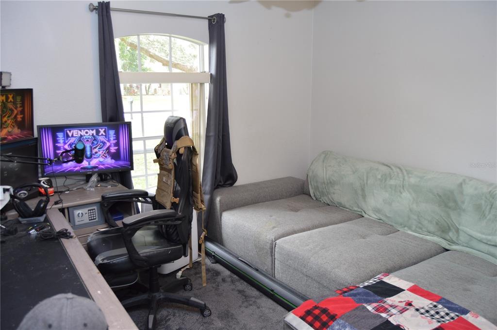 2291 Danforth Road Spring Hill, FL 34608 - Photo 39 of 57 a bedroom with a bed and a flat screen tv