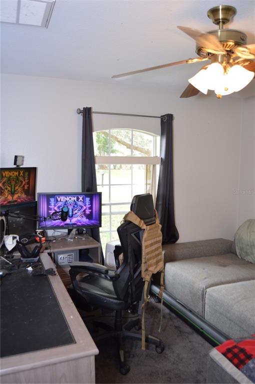 2291 Danforth Road Spring Hill, FL 34608 - Photo 41 of 57 a bedroom with a bed and a chandelier