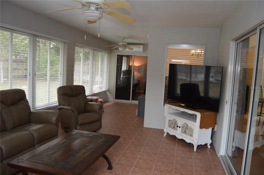 2291 Danforth Road Spring Hill, FL 34608 - Photo 49 of 57 a living room with furniture and a flat screen tv