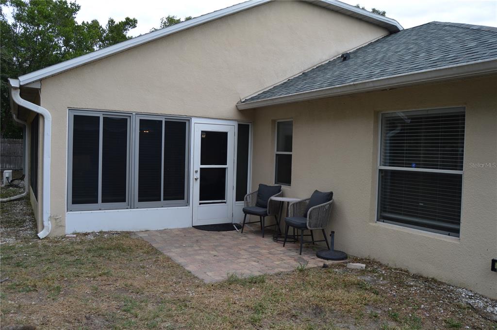 2291 Danforth Road Spring Hill, FL 34608 - Photo 50 of 57 a backyard of a house with table and chairs
