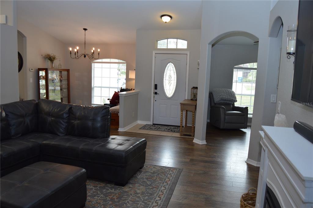 2291 Danforth Road Spring Hill, FL 34608 - Photo 9 of 57 a living room with furniture and a large mirror