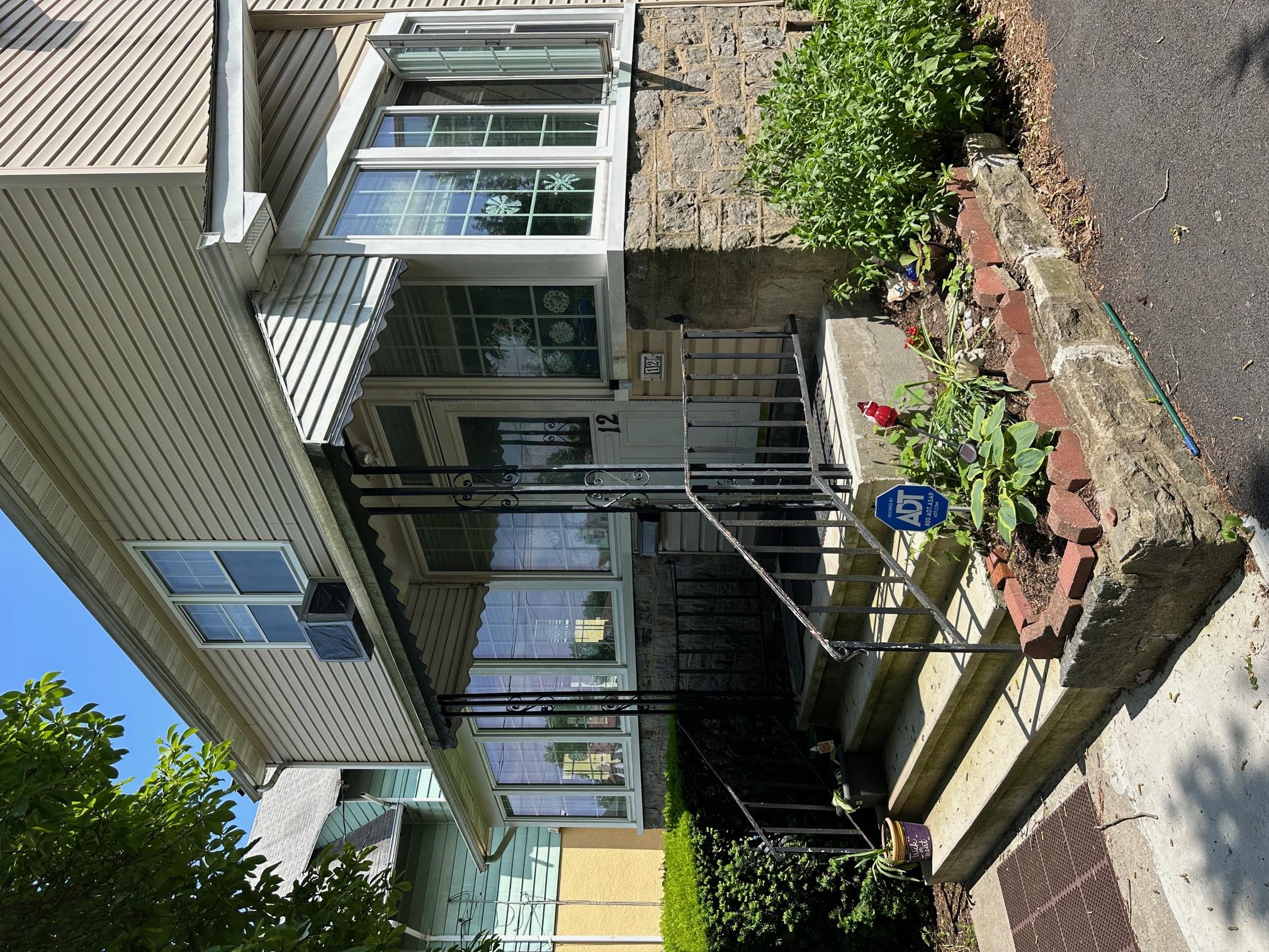 12 Ferdinand Place New Rochelle, NY 10801 - Photo 1 of 1 View of front of home with stone siding and cooling unit