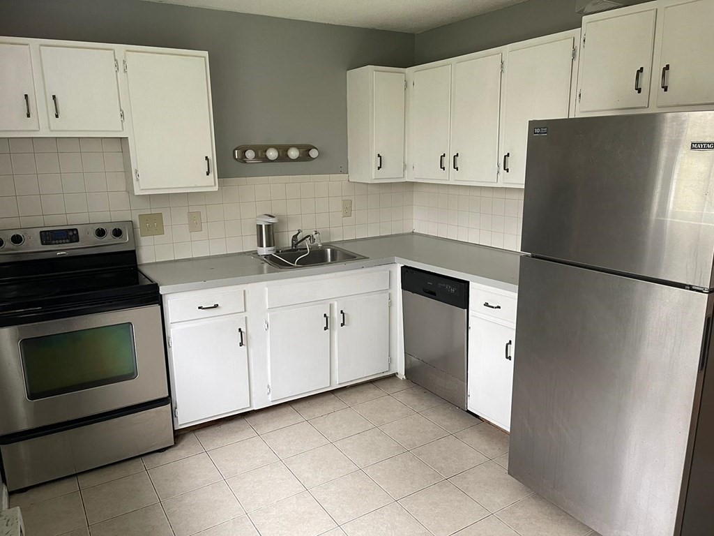 148 Boston Post Road East, Unit 10 Marlborough, MA 01752 - Photo 1 of 10 a kitchen with cabinets appliances and a counter space