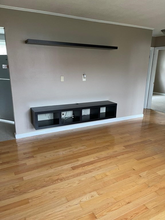 148 Boston Post Road East, Unit 10 Marlborough, MA 01752 - Photo 2 of 10 a view of an empty room with wooden floor