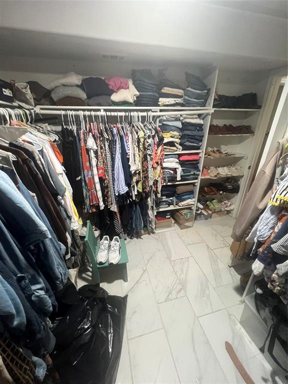 3424 Cardinal Lane Irving, TX 75062 - Photo 13 of 17 a view of walk in closet with clothes and shoes