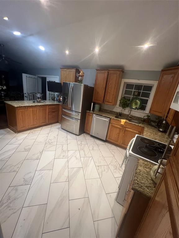 3424 Cardinal Lane Irving, TX 75062 - Photo 7 of 17 a kitchen with stainless steel appliances a refrigerator sink and microwave