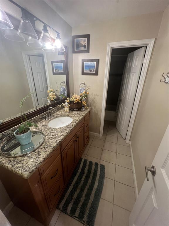 3424 Cardinal Lane Irving, TX 75062 - Photo 8 of 17 a bathroom with a granite countertop sink a toilet and a mirror