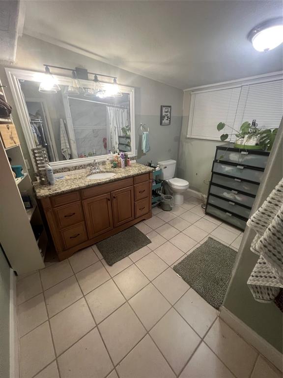 3424 Cardinal Lane Irving, TX 75062 - Photo 10 of 17 a bathroom with a sink mirror and toilet