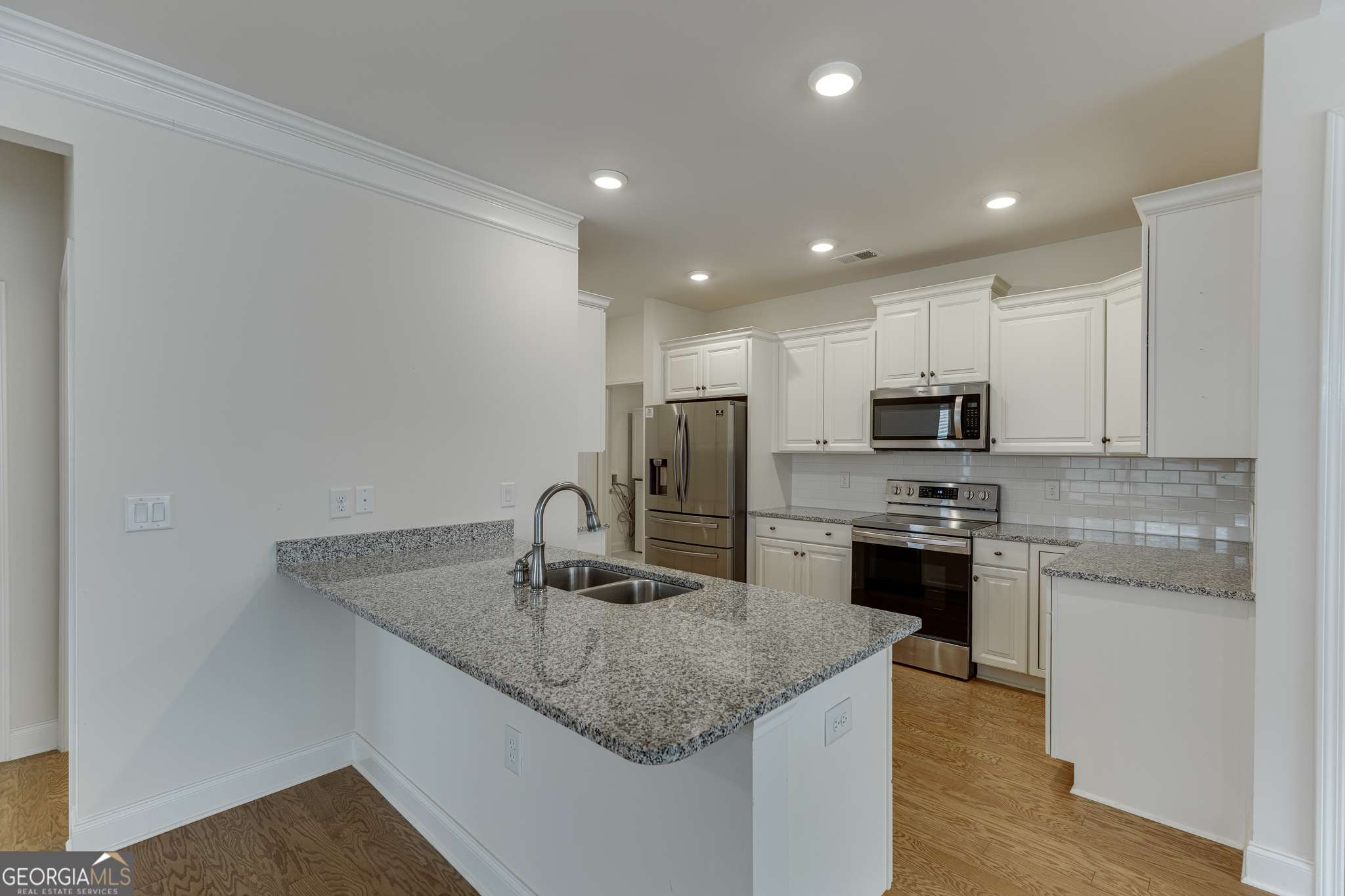 3765 Ridgehurst Drive Buford, GA 30518 - Photo 13 of 44 Updated kitchen with granite countertops, breakfast bar, and open sightlines