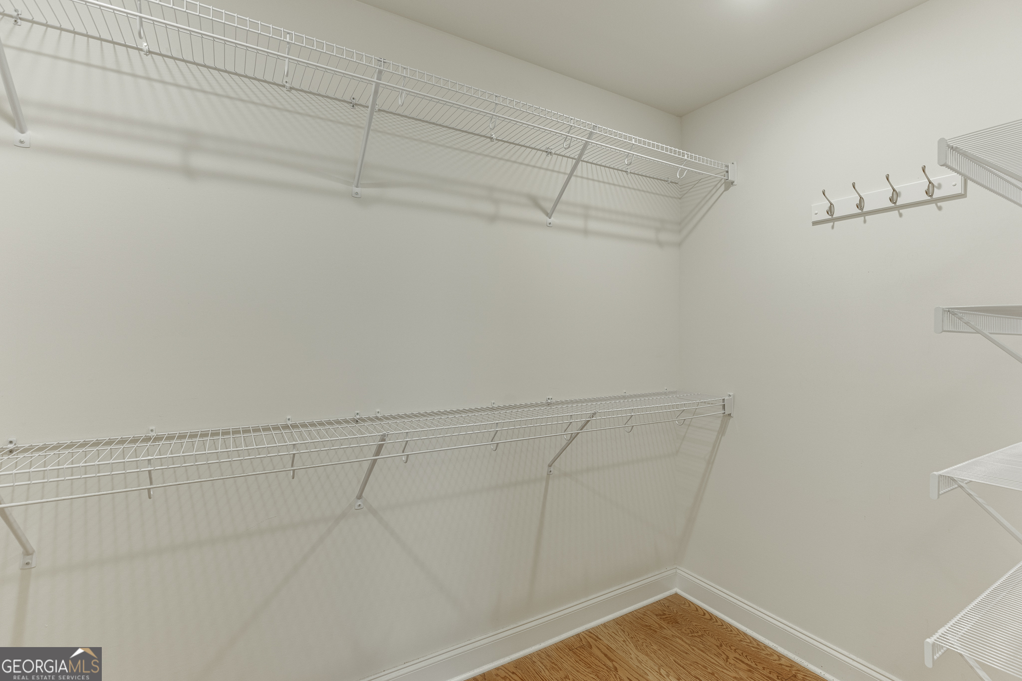 3765 Ridgehurst Drive Buford, GA 30518 - Photo 32 of 44 Large walk-in closet with built-in shelving and storage system.