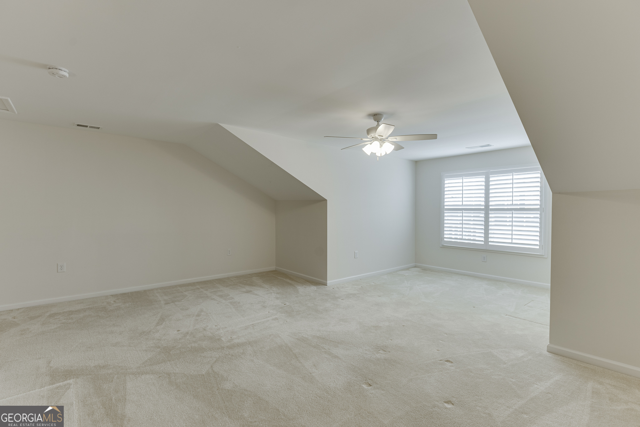3765 Ridgehurst Drive Buford, GA 30518 - Photo 36 of 44 Bonus room with angled ceiling lines and bright natural light.