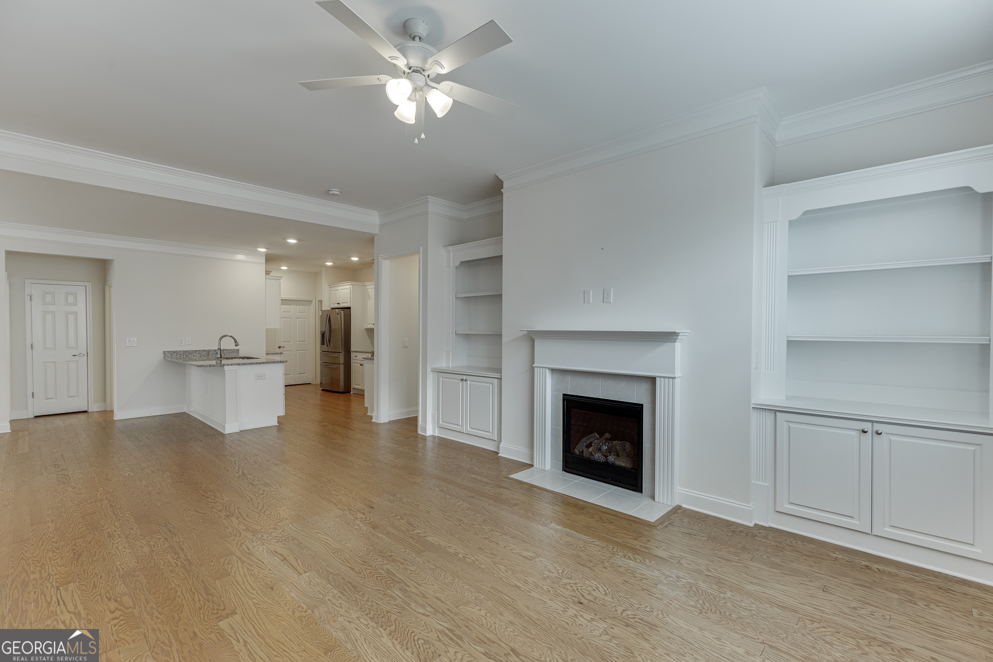 3765 Ridgehurst Drive Buford, GA 30518 - Photo 9 of 44 Open living area with fireplace and custom built-in shelving.