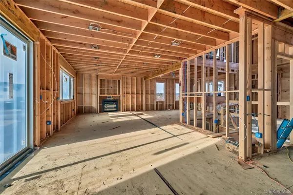 an empty room with wooden floor and fireplace