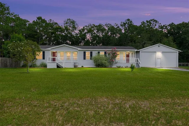 a front view of a house with a garden
