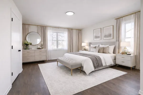 a spacious bedroom with a bed and a large window